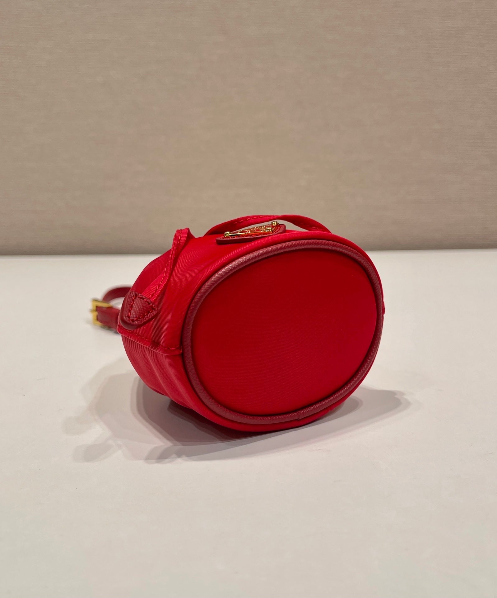 MINI BUCKET BAG 10 IN RED RE-NYLON AND SAFFIANO LEATHER STRAP