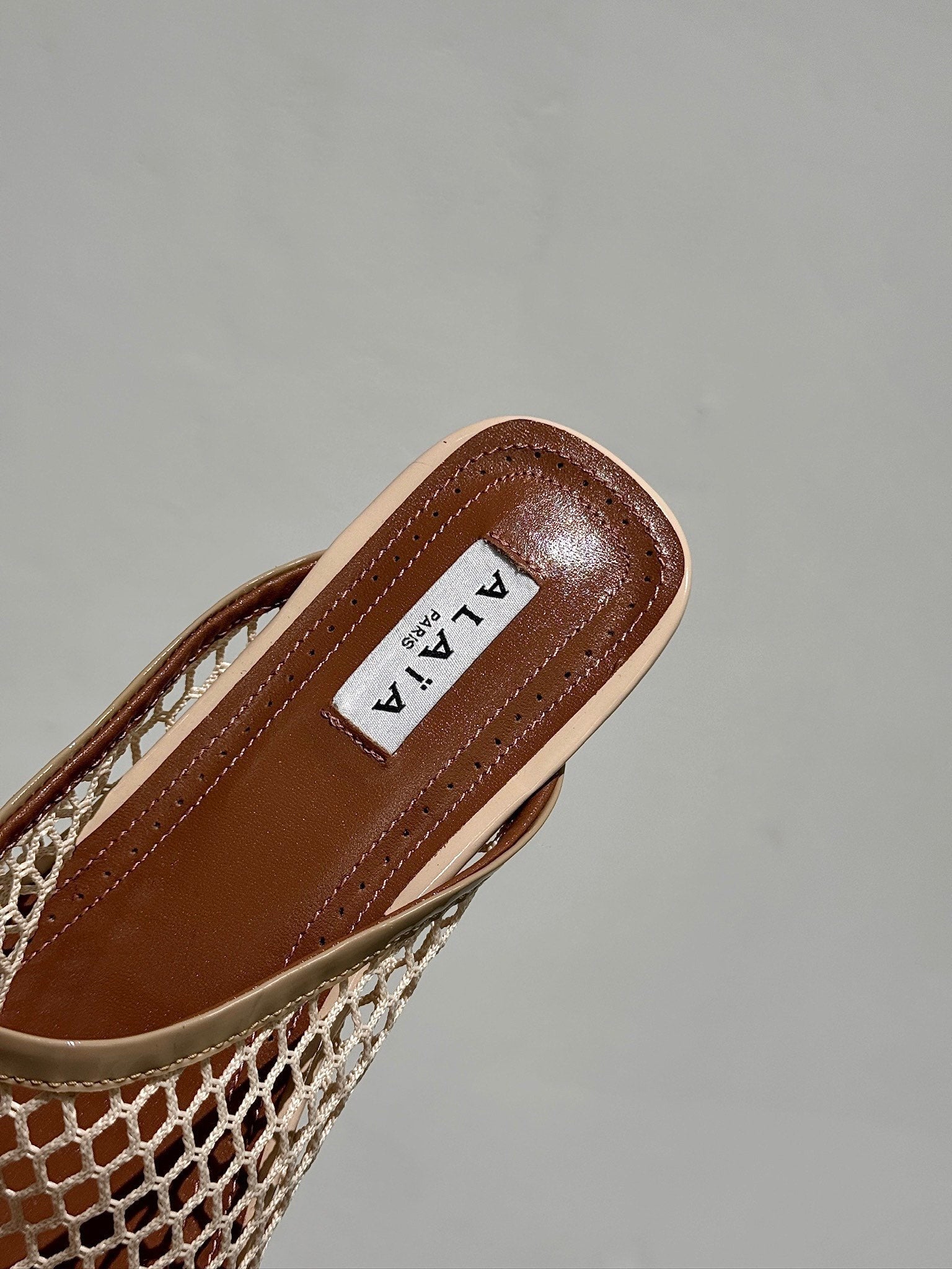 ALAIA FLAT MULES IN BEIGE MESH FISHNET