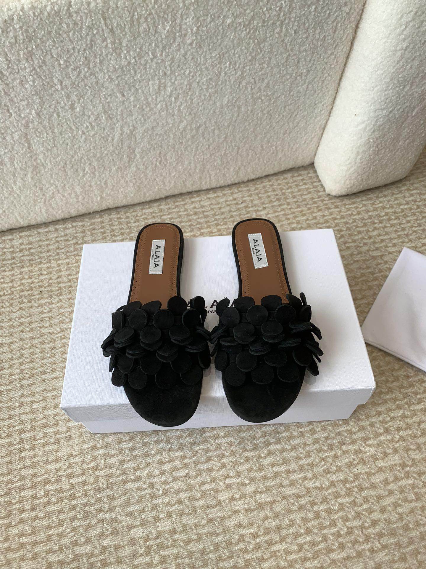 ALAIA FLAT MULE IN BLACK SUEDE