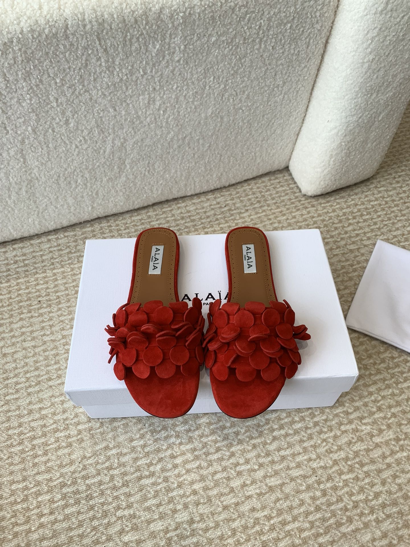 ALAIA FLAT MULE IN CHERRY RED SUEDE