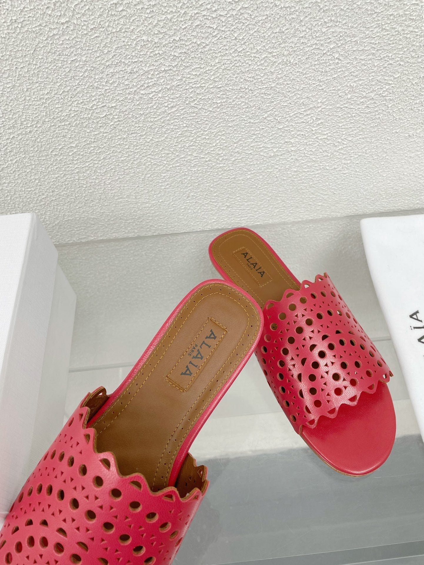 ALAIA VIENNE FLAT MULES IN CHERRY RED LAMBSKIN