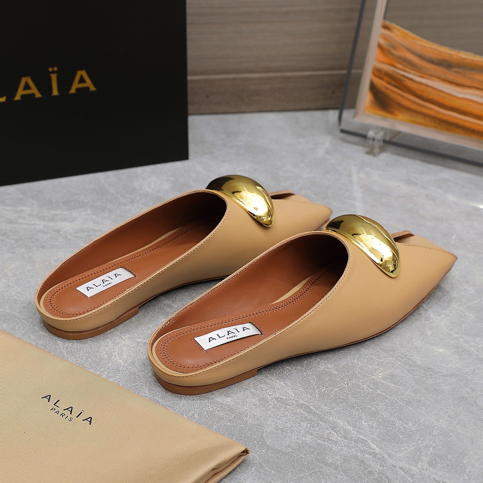 ALAIA FLAT MULE IN SEPIA TAN LAMBSKIN WITH GOLD HARDWARE