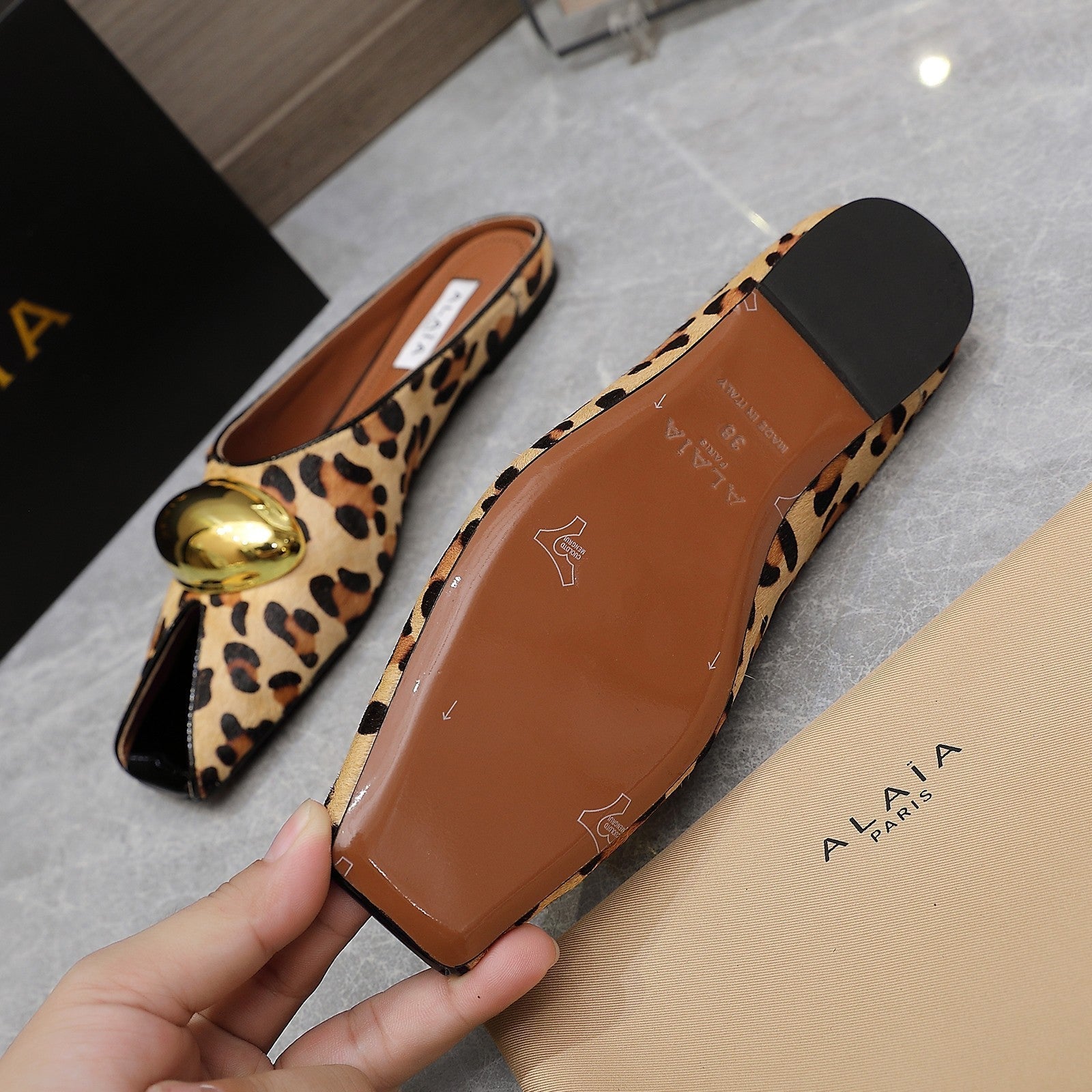 ALAIA FLAT MULE IN LEOPARD LAMBSKIN WITH GOLD HARDWARE