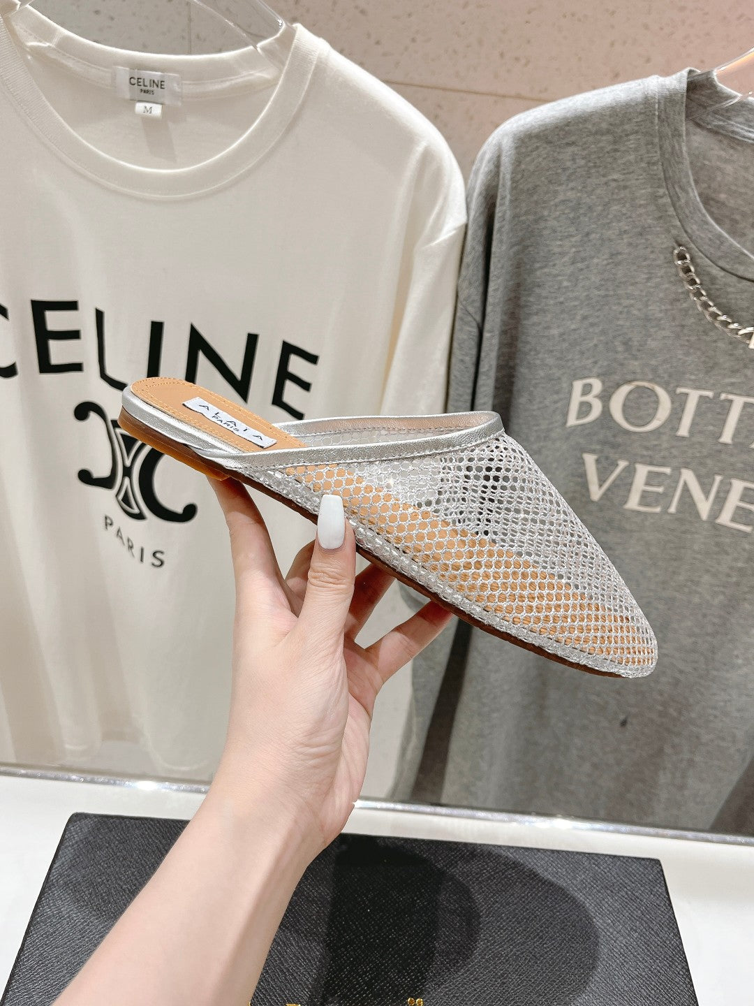 ALAIA FLAT MULES IN SILVER MESH FISHNET